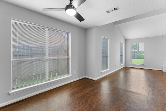 unfurnished room with vaulted ceiling, ceiling fan, dark hardwood / wood-style floors, and a textured ceiling