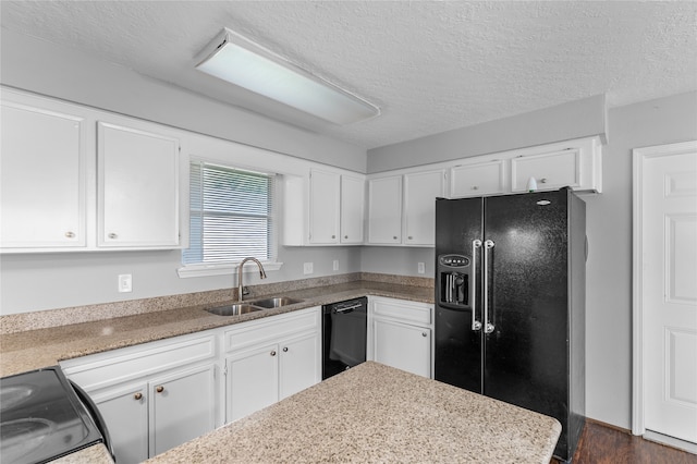 kitchen featuring white cabinets, sink, a textured ceiling, dark wood-type flooring, and black appliances