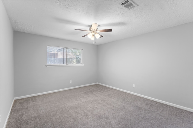 carpeted spare room with a textured ceiling and ceiling fan