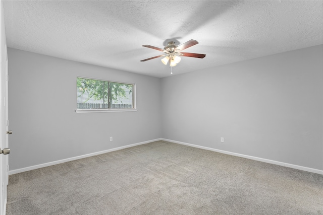 spare room with ceiling fan, a textured ceiling, and carpet floors