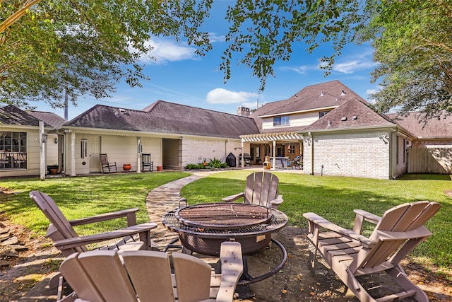 rear view of house featuring an outdoor fire pit, a patio area, and a yard