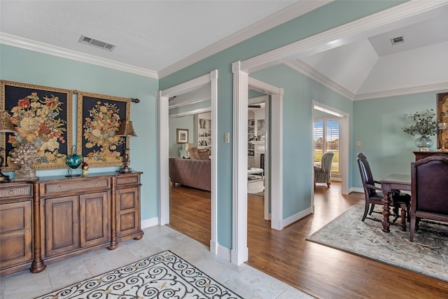 611 S Cleveland St, Dayton, TX 77535 - bar with visible vents, baseboards, crown molding, and light wood-type flooring