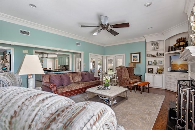 living room featuring ornamental molding, dark hardwood / wood-style floors, built in features, and ceiling fan