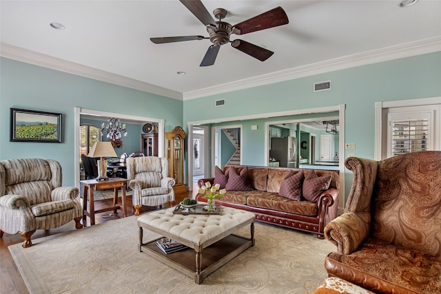 living room featuring crown molding, hardwood / wood-style flooring, and ceiling fan