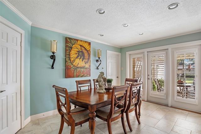 dining area with crown molding and a textured ceiling