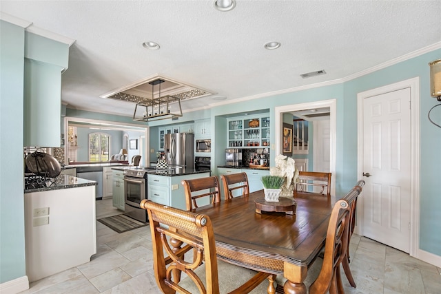 dining space featuring crown molding and a textured ceiling