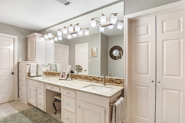 bathroom featuring vanity, tile patterned floors, and a textured ceiling