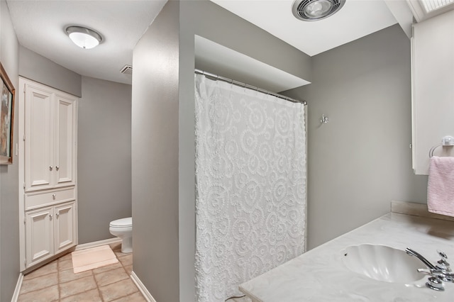 bathroom with toilet, vanity, tile patterned floors, and a shower with shower curtain