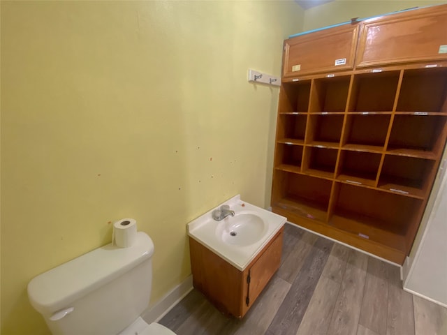 bathroom featuring hardwood / wood-style floors, toilet, and vanity