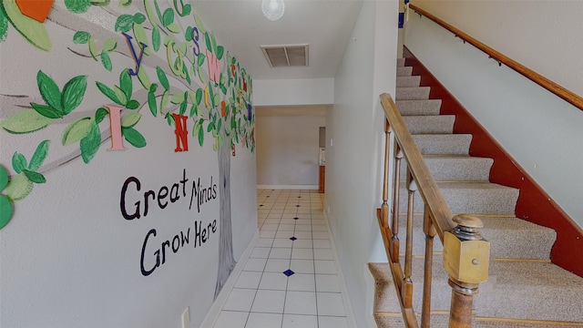 staircase featuring tile patterned floors