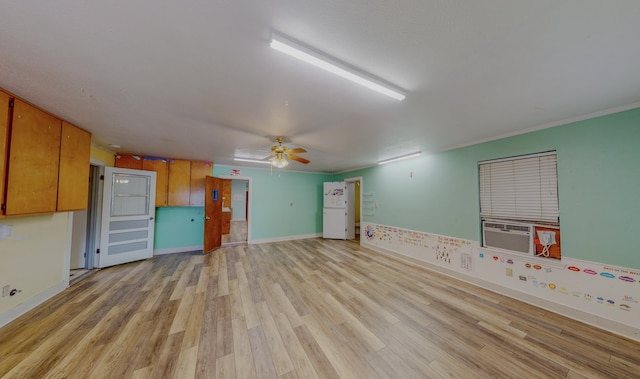 unfurnished room featuring ceiling fan, light hardwood / wood-style flooring, ornamental molding, and cooling unit