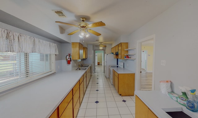 kitchen featuring sink, white appliances, ceiling fan, and light tile patterned flooring