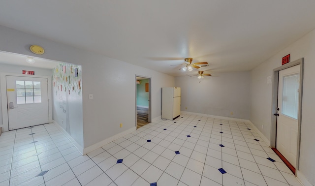 tiled empty room with ceiling fan