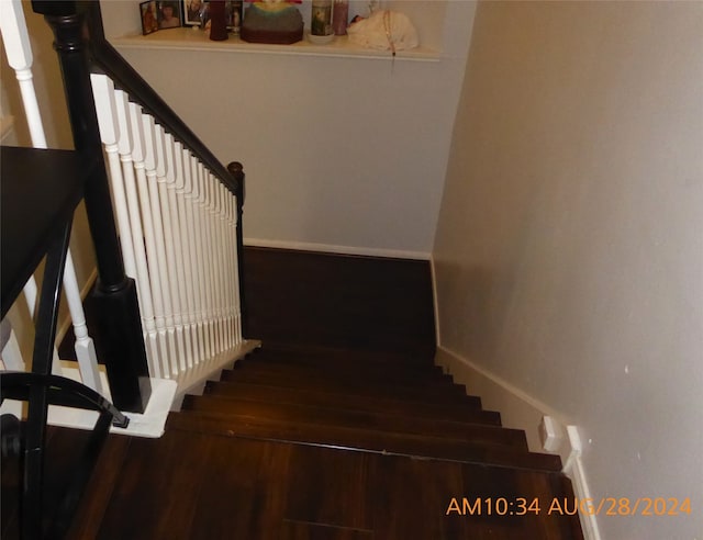 staircase with wood-type flooring