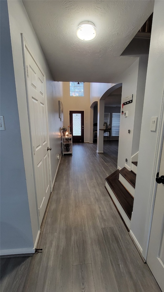 corridor featuring dark hardwood / wood-style floors and a textured ceiling