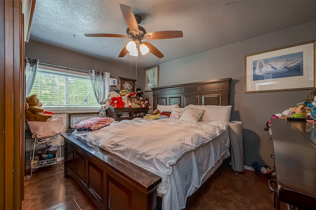 tiled bedroom featuring ceiling fan and a textured ceiling