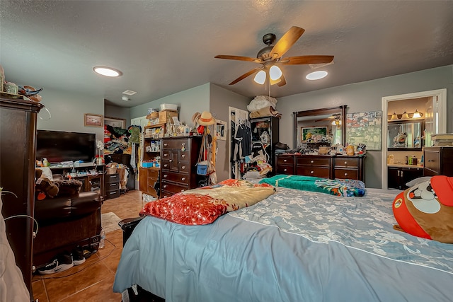 tiled bedroom with ceiling fan and connected bathroom