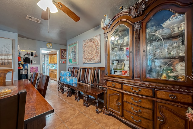 tiled dining space featuring ceiling fan