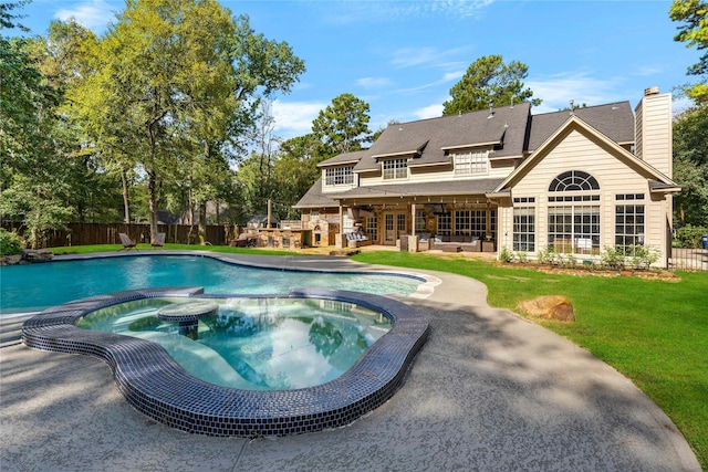 view of pool featuring a lawn, a patio area, and an in ground hot tub