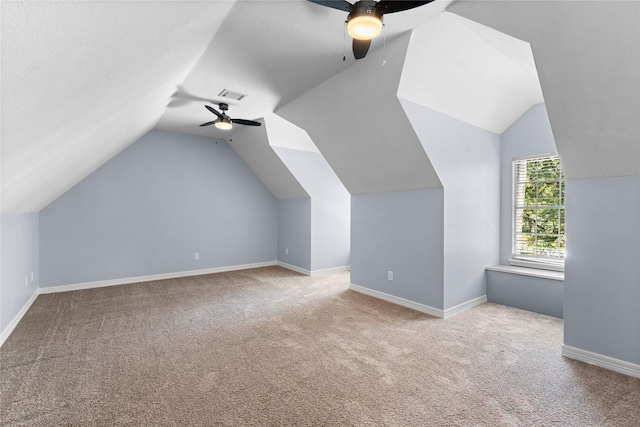 additional living space featuring ceiling fan, light carpet, and vaulted ceiling