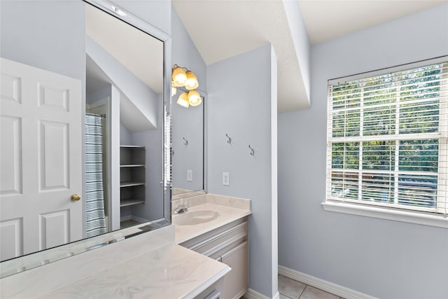 bathroom featuring tile patterned floors, vanity, and lofted ceiling