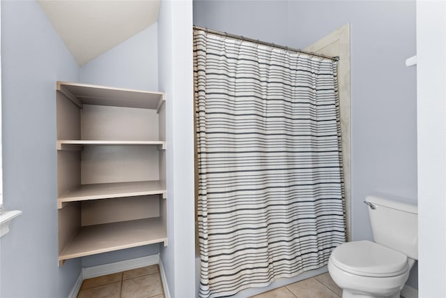 bathroom featuring tile patterned floors, a shower with shower curtain, lofted ceiling, and toilet