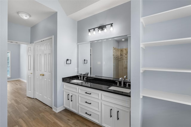 bathroom with hardwood / wood-style floors, vanity, an enclosed shower, and lofted ceiling