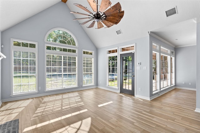 unfurnished living room with lofted ceiling, light hardwood / wood-style flooring, ceiling fan, and ornamental molding