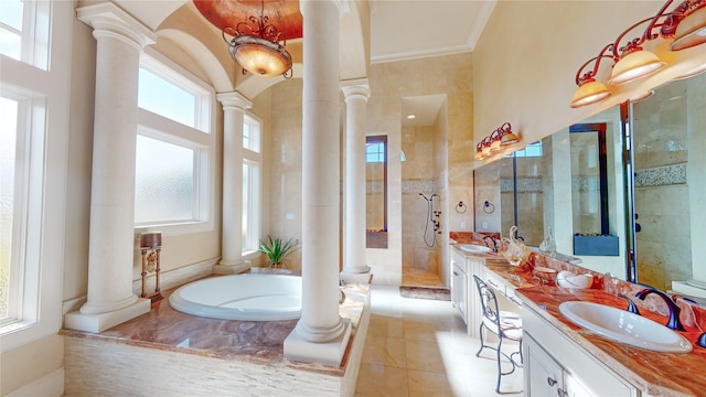 bathroom with tile patterned floors, vanity, a healthy amount of sunlight, and ornate columns