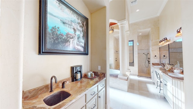 bathroom with ornate columns, crown molding, tile patterned floors, and vanity