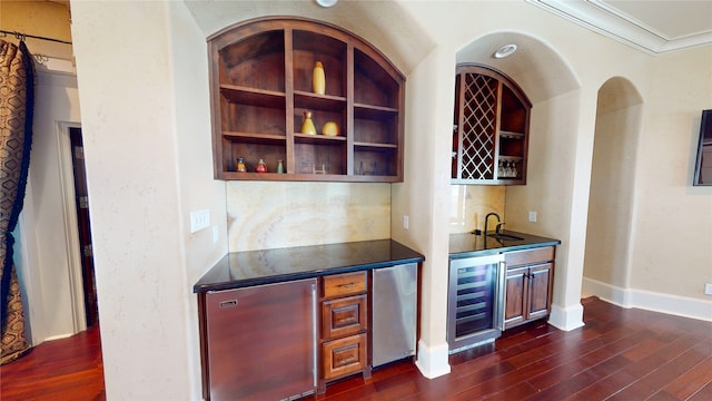 bar featuring sink, ornamental molding, wine cooler, and dark hardwood / wood-style flooring