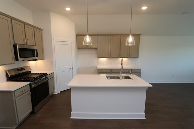 kitchen featuring stainless steel appliances, a center island with sink, hanging light fixtures, and sink