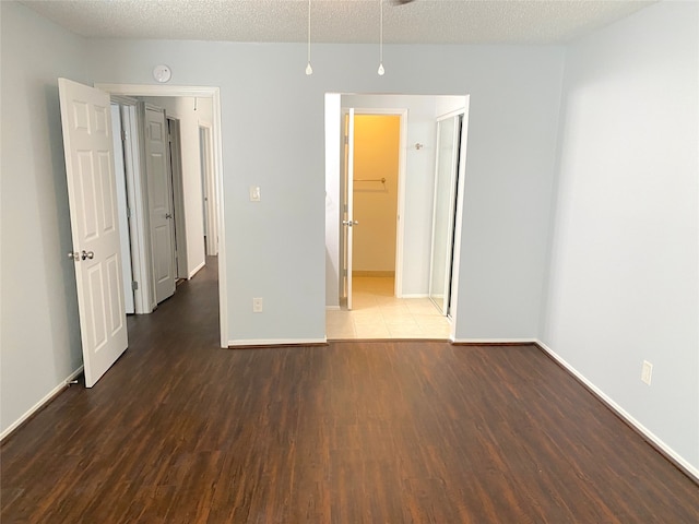 spare room featuring hardwood / wood-style floors and a textured ceiling