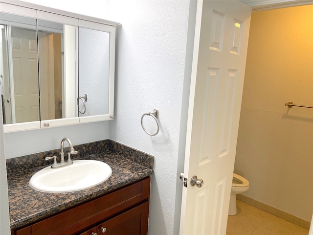 bathroom featuring vanity, toilet, and tile patterned flooring