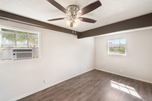 empty room with a ceiling fan, a textured ceiling, wood finished floors, cooling unit, and baseboards