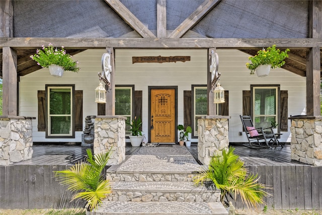 view of exterior entry featuring a porch