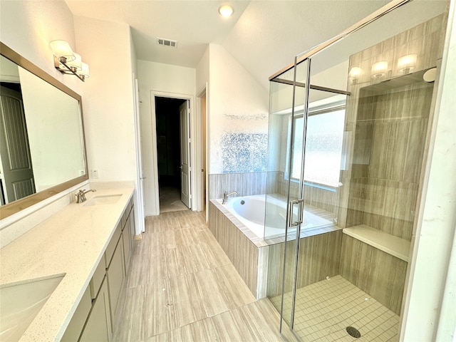 bathroom featuring vanity, separate shower and tub, and lofted ceiling