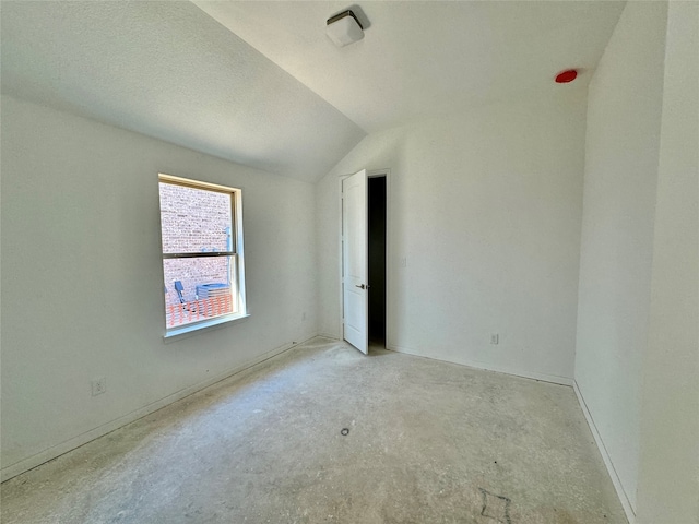 spare room featuring vaulted ceiling