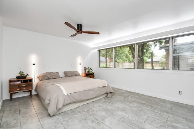 tiled bedroom with multiple windows and ceiling fan