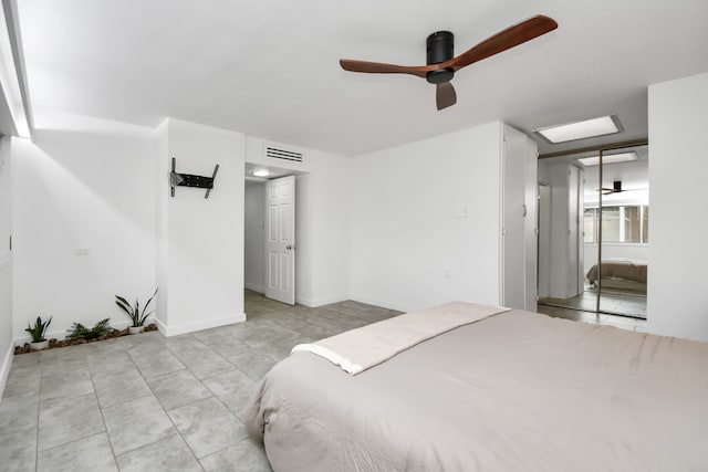 tiled bedroom featuring ceiling fan and a closet