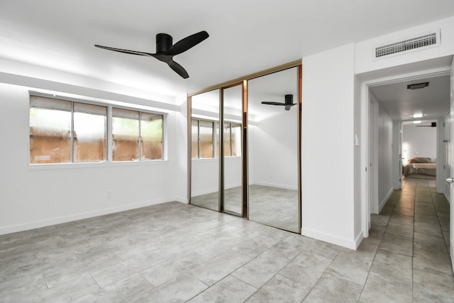 unfurnished bedroom with a closet, ceiling fan, and light tile patterned floors