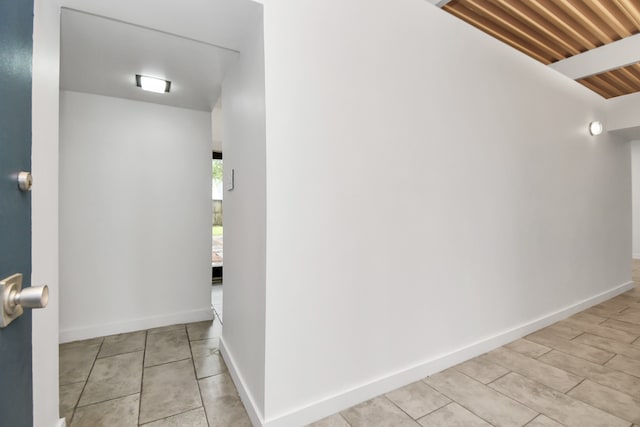 hall featuring light tile patterned floors