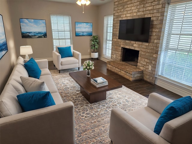 living room with hardwood / wood-style flooring, a fireplace, and ceiling fan