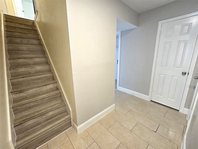 stairs featuring tile patterned flooring