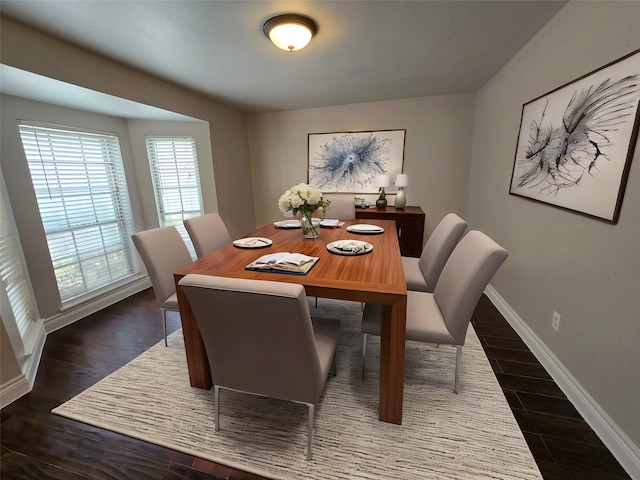 dining space featuring dark wood-type flooring and a healthy amount of sunlight