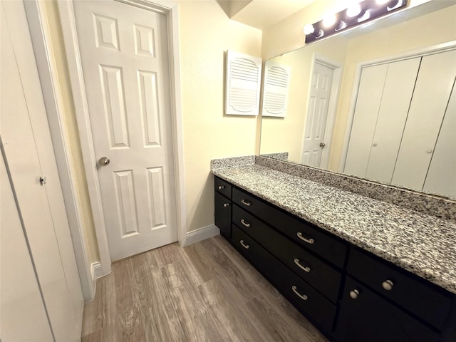 bathroom featuring hardwood / wood-style flooring and vanity