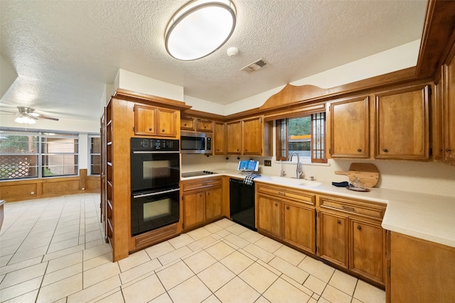 kitchen with black appliances, ceiling fan, plenty of natural light, and sink