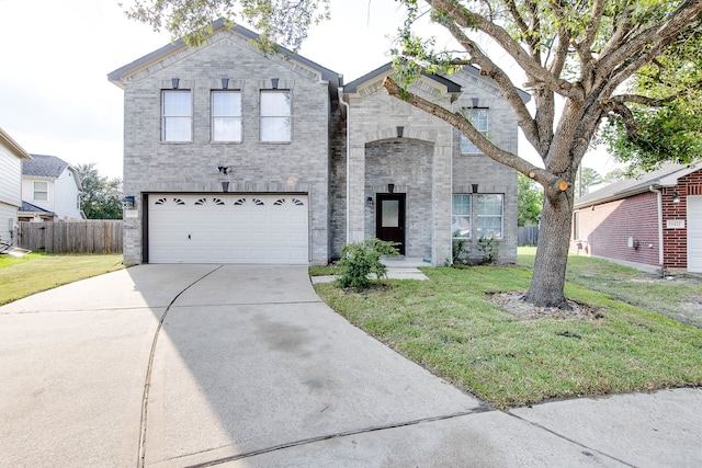 view of front of home featuring a garage and a front lawn