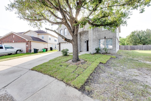 view of front of house with a garage and a front lawn