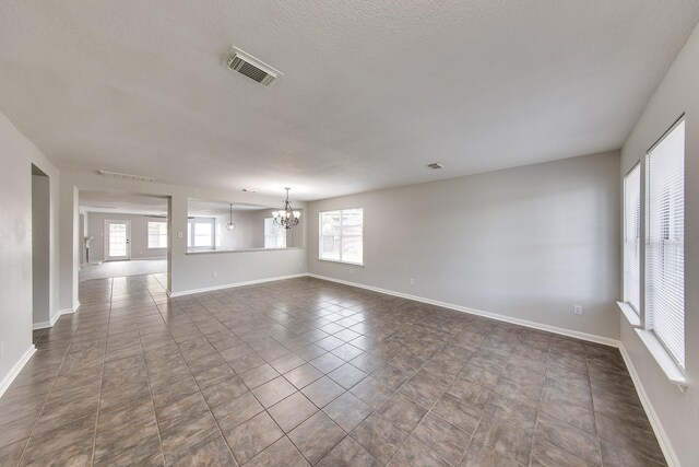 interior space with a wealth of natural light and a notable chandelier